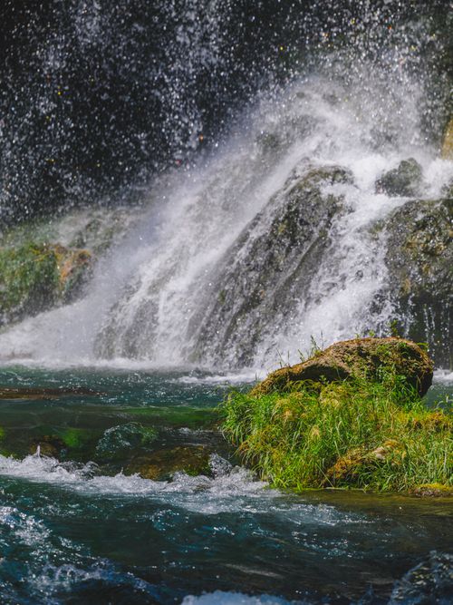 Free Stunning waterfall cascading over mossy rocks in a lush green environment, showcasing the beauty of nature. Stock Photo