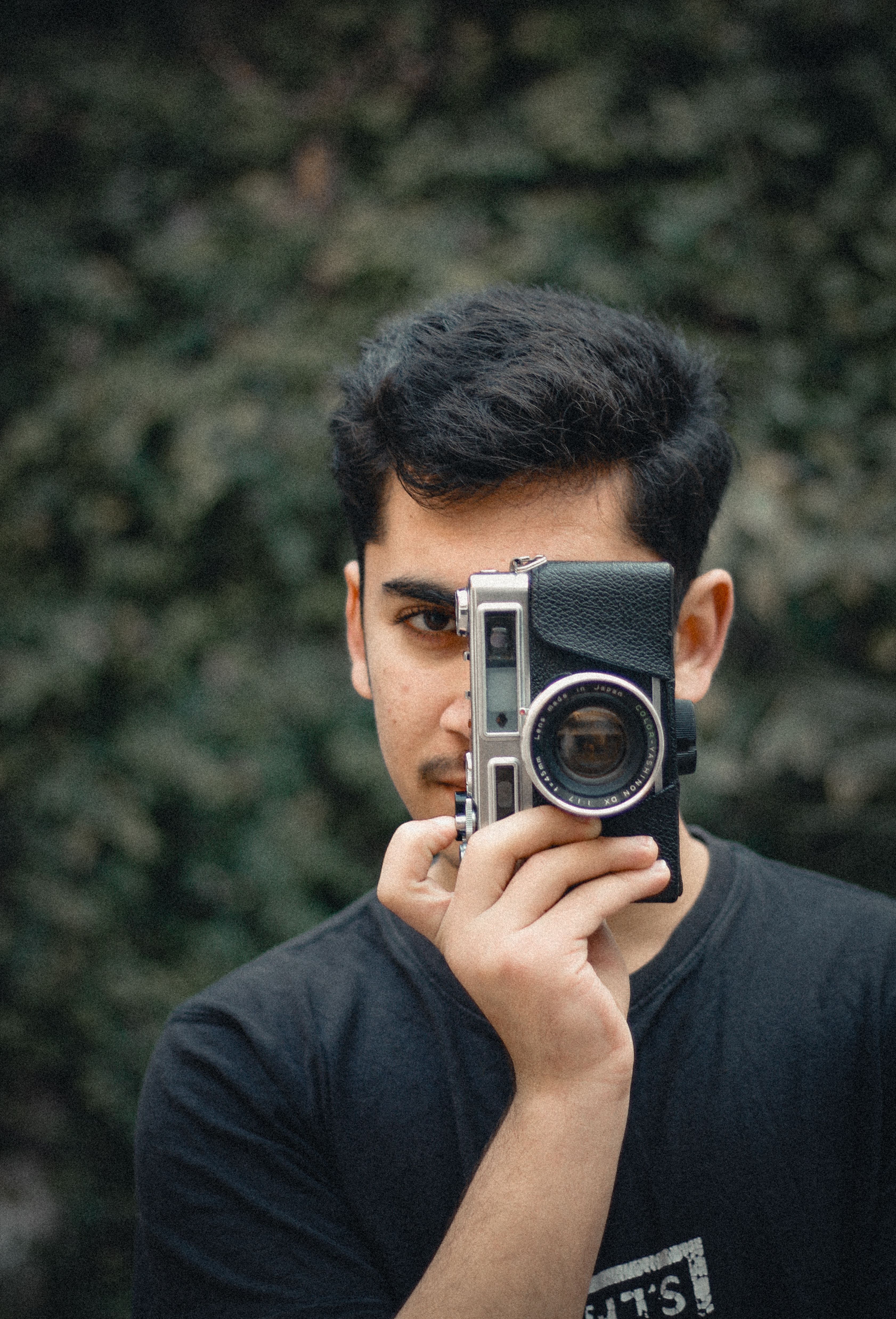 Young Photographer Capturing with Vintage Camera · Free Stock Photo