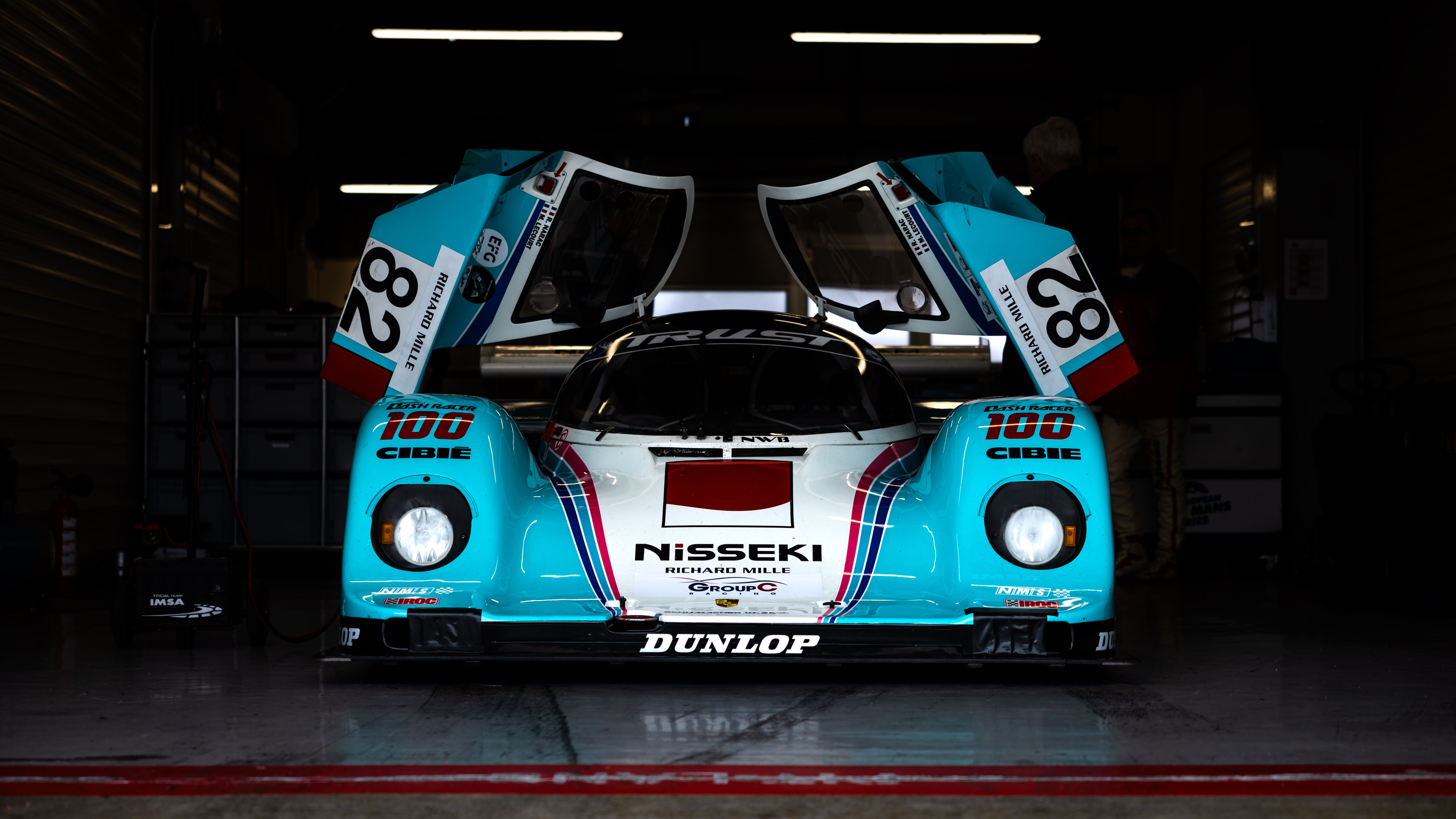 Classic Racing Car in Garage with Open Doors · Free Stock Photo