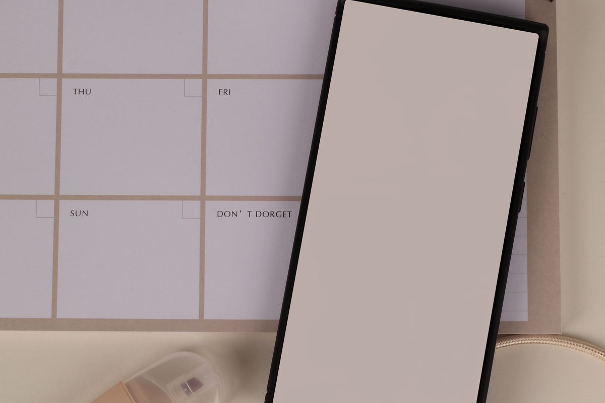 Weekly planner and phone used for tracking irregular periods