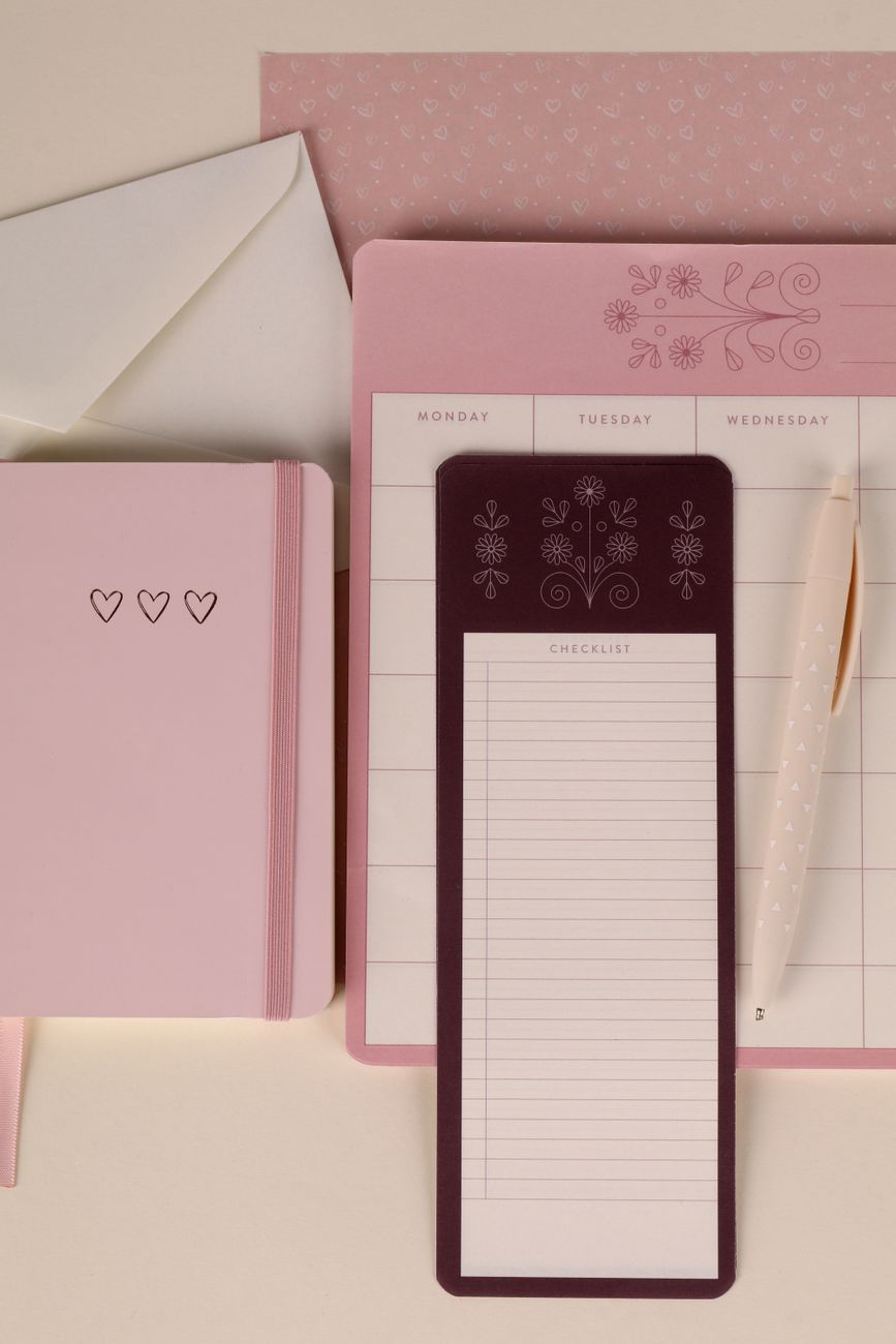 notebook with a handwritten checklist and a pen on a desk