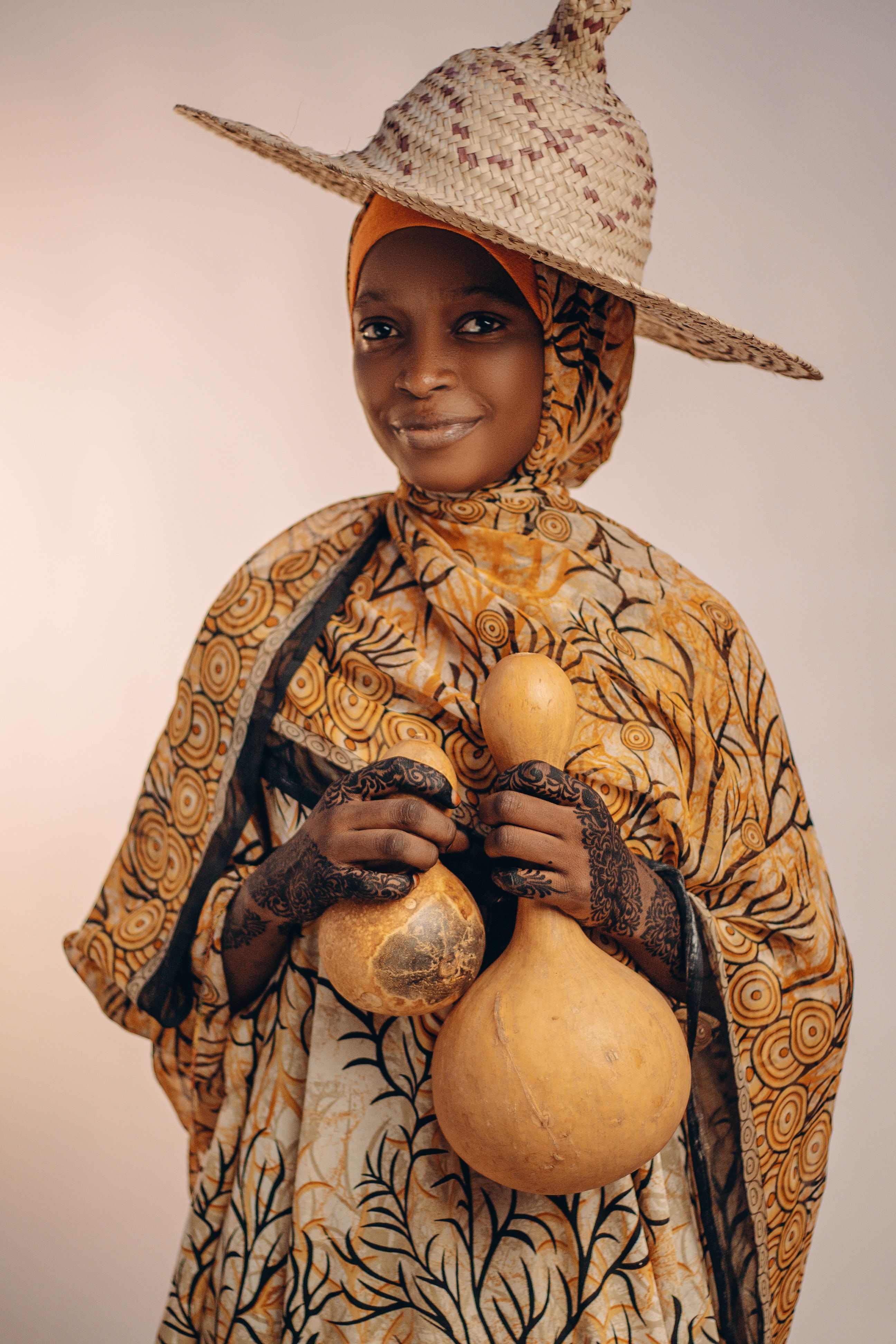 Traditional African Attire with Calabash Display · Free Stock Photo