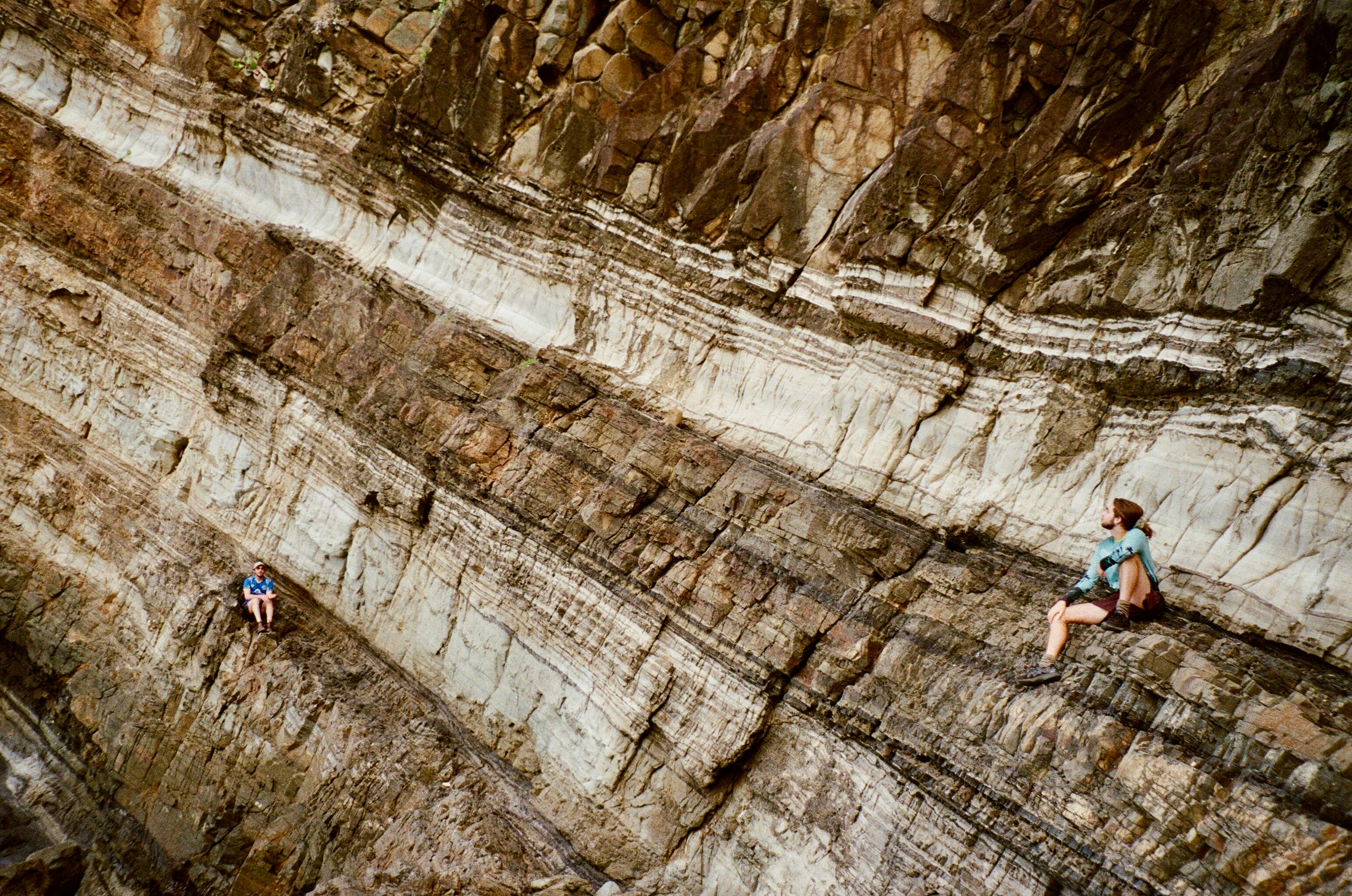 Climbers braving rugged rock formations in New South Wales, showcasing geological marvels.