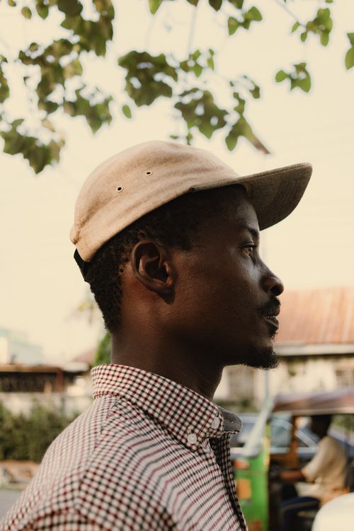 Free Side profile portrait of an African man outdoors in Abuja, Nigeria with natural background. Stock Photo
