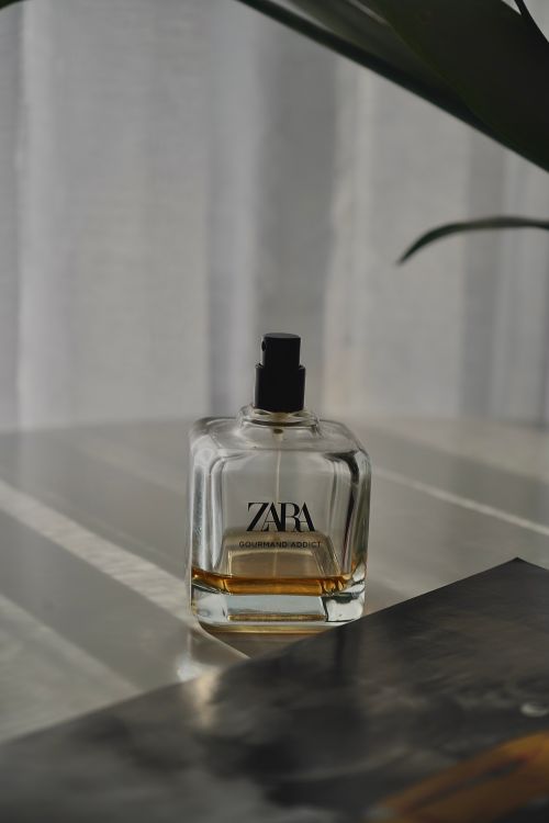 Free Elegant Zara perfume bottle on a surface with soft light and shadows. Stock Photo
