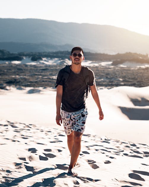 Man Walking Barefoot on Sand · Free Stock Photo