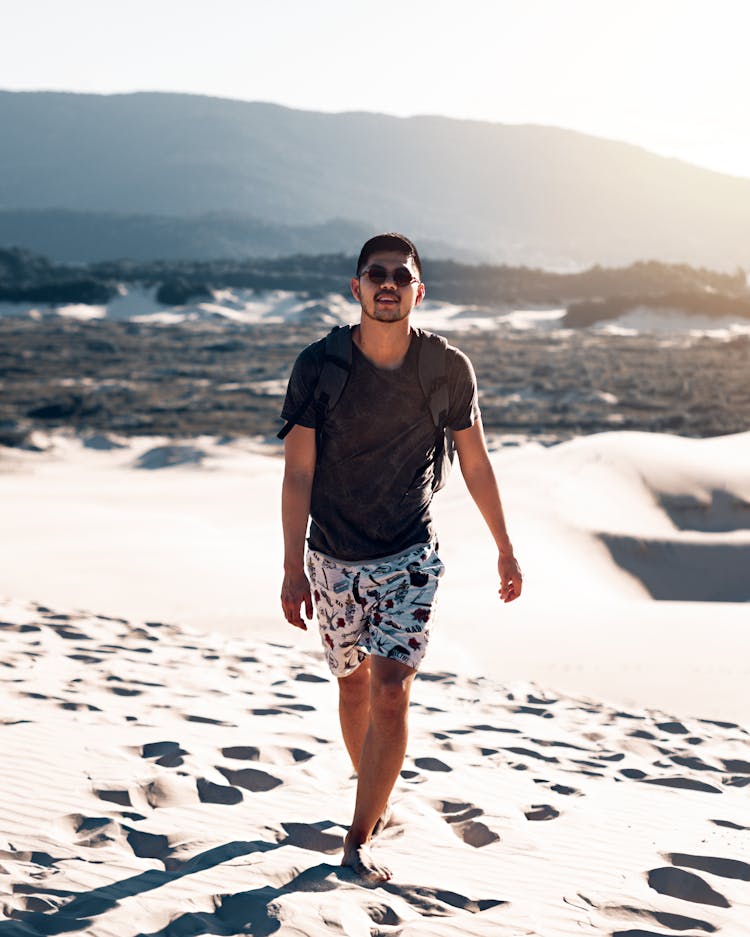 Man Walking Barefoot On Sand