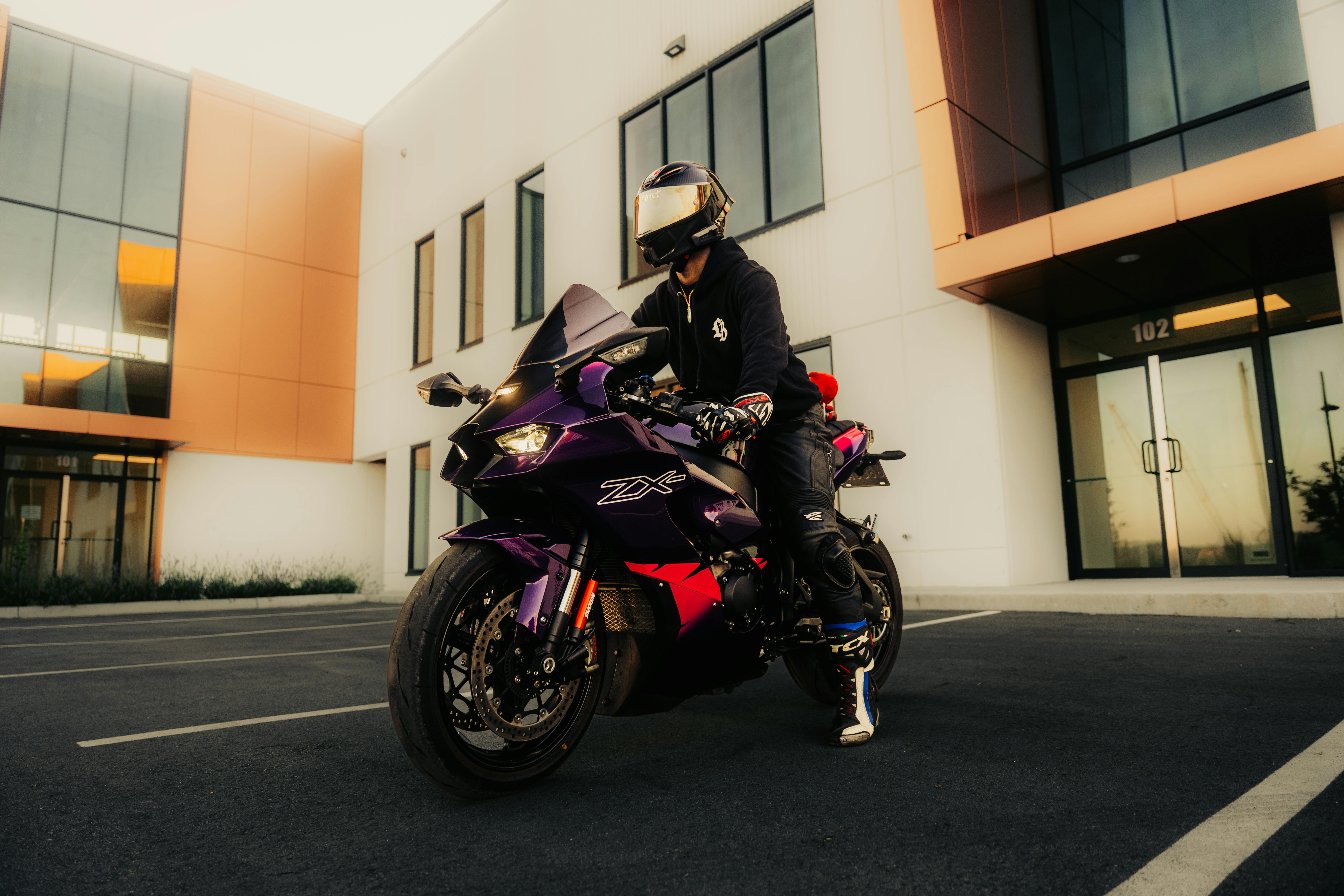 Motorcyclist on a sportbike in a modern urban environment, showcasing style and adventure.