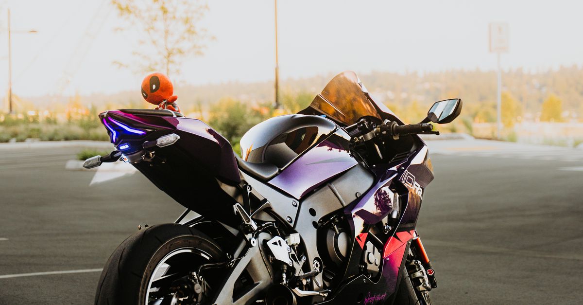 Violet Sport Motorcycle Parked in Urban Setting · Free Stock Photo