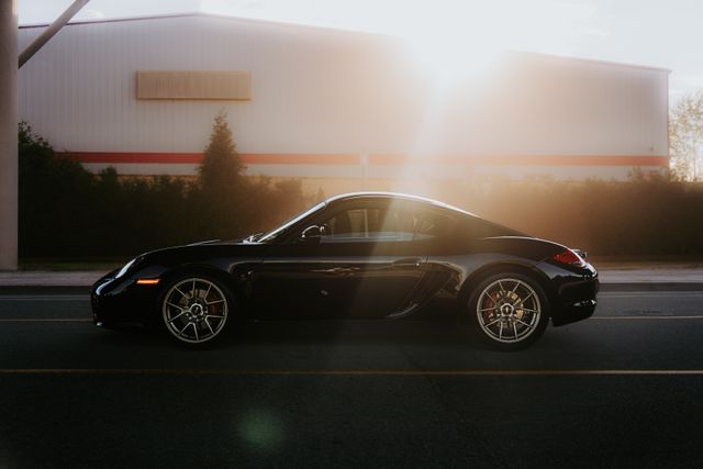 Black coupe parked kerbside in low sun — photo by Luke Miller on Pexels