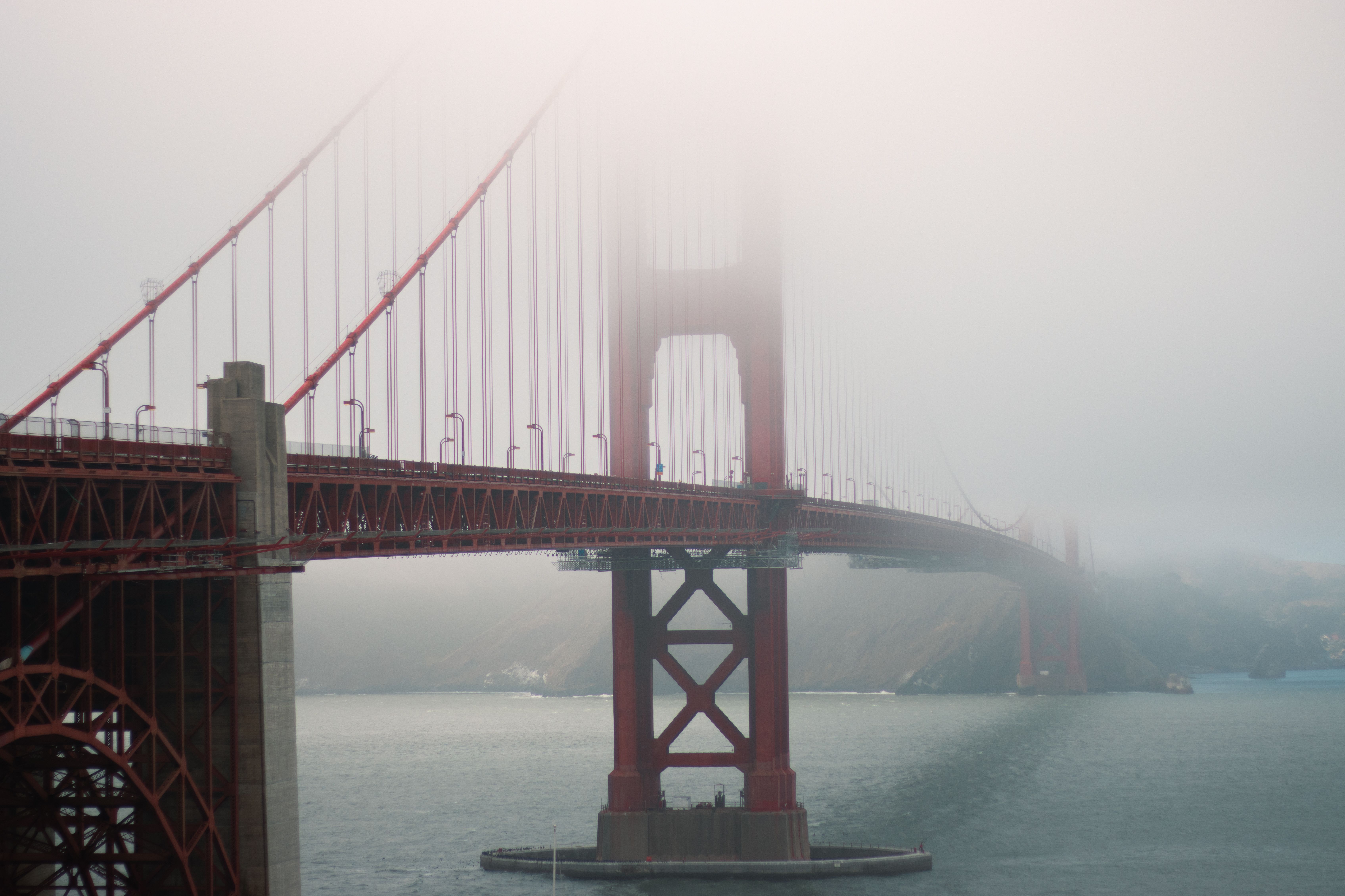 Atmospheric view of the Golden Gate Bridge enveloped in fog, showcasing its iconic design.