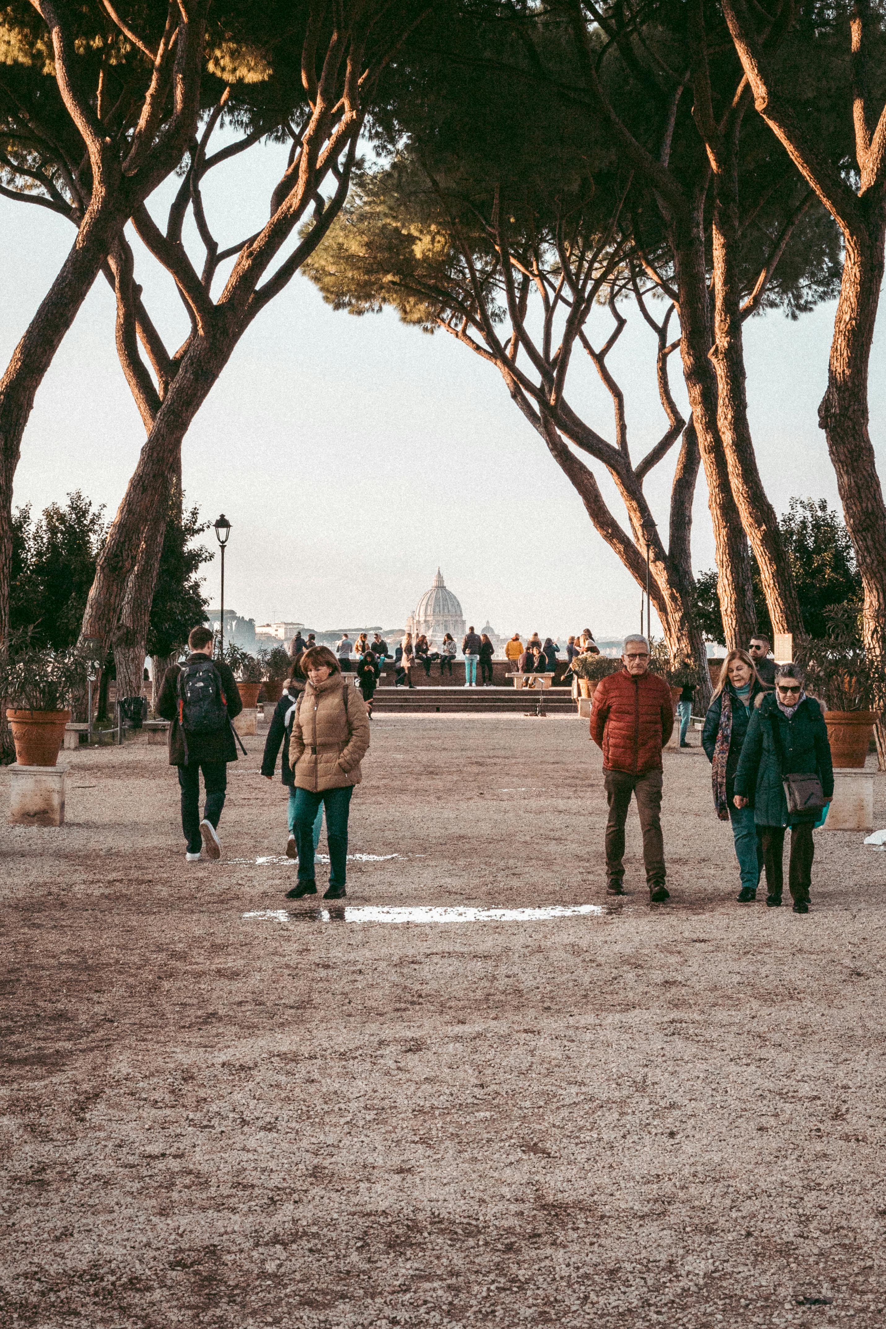 people walking on an unpaved road