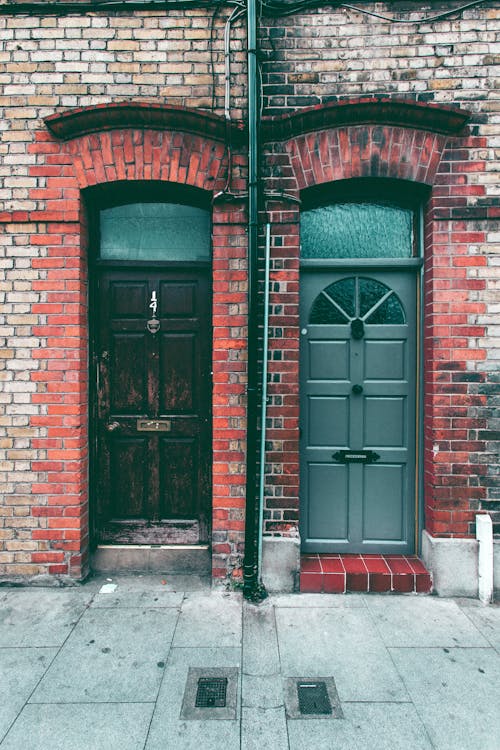 Brown Wooden Door on Red Brick Wall