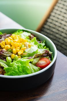 Colorful salad with lettuce, corn, and cherry tomatoes, perfect for healthy eating.