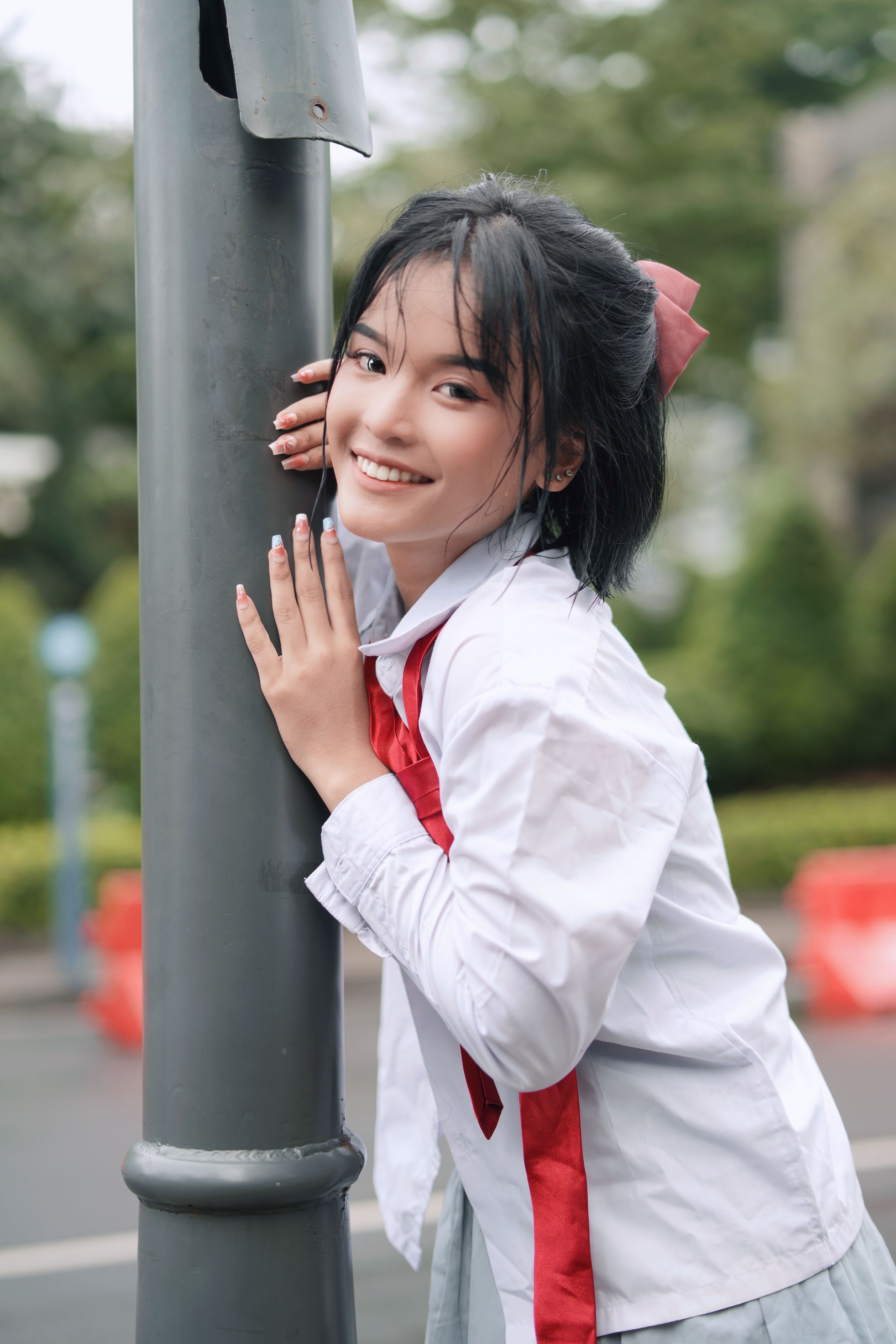 Smiling Young Woman Posing Outdoors on a Sunny Day