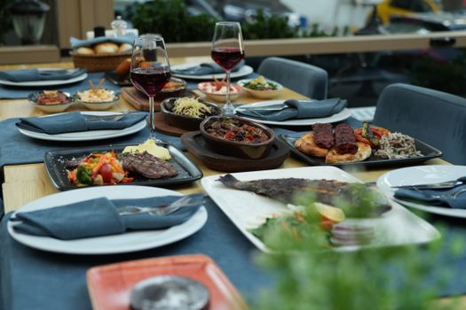 An elegant dining setup featuring diverse dishes, wine glasses, and sophisticated tableware.