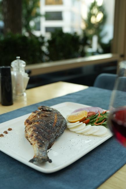 grilled fish plated with lemon