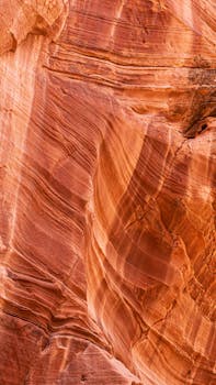 Explore the intricate layers of an Arizona sandstone canyon, showcasing warm, orange earth tones.