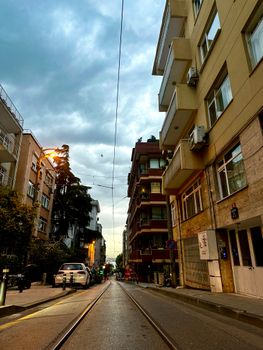 Evening street scene in İstanbul with residential buildings and moody sky.