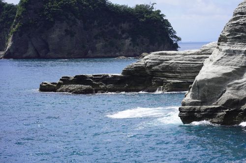 Free Beautiful rocky cliffs and blue ocean in Nishiizu, Shizuoka, Japan, under a clear sky. Stock Photo