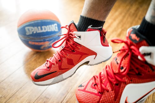 Person Wearing Pair of Red-and-white Nike Lebron 12 Shoes