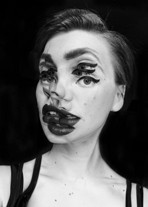 Grayscale Portrait Photography of a Woman With Triple Illusion Makeup