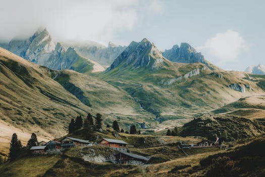 Beautiful mountain landscape with alpine village nestled in the valley under clear skies.