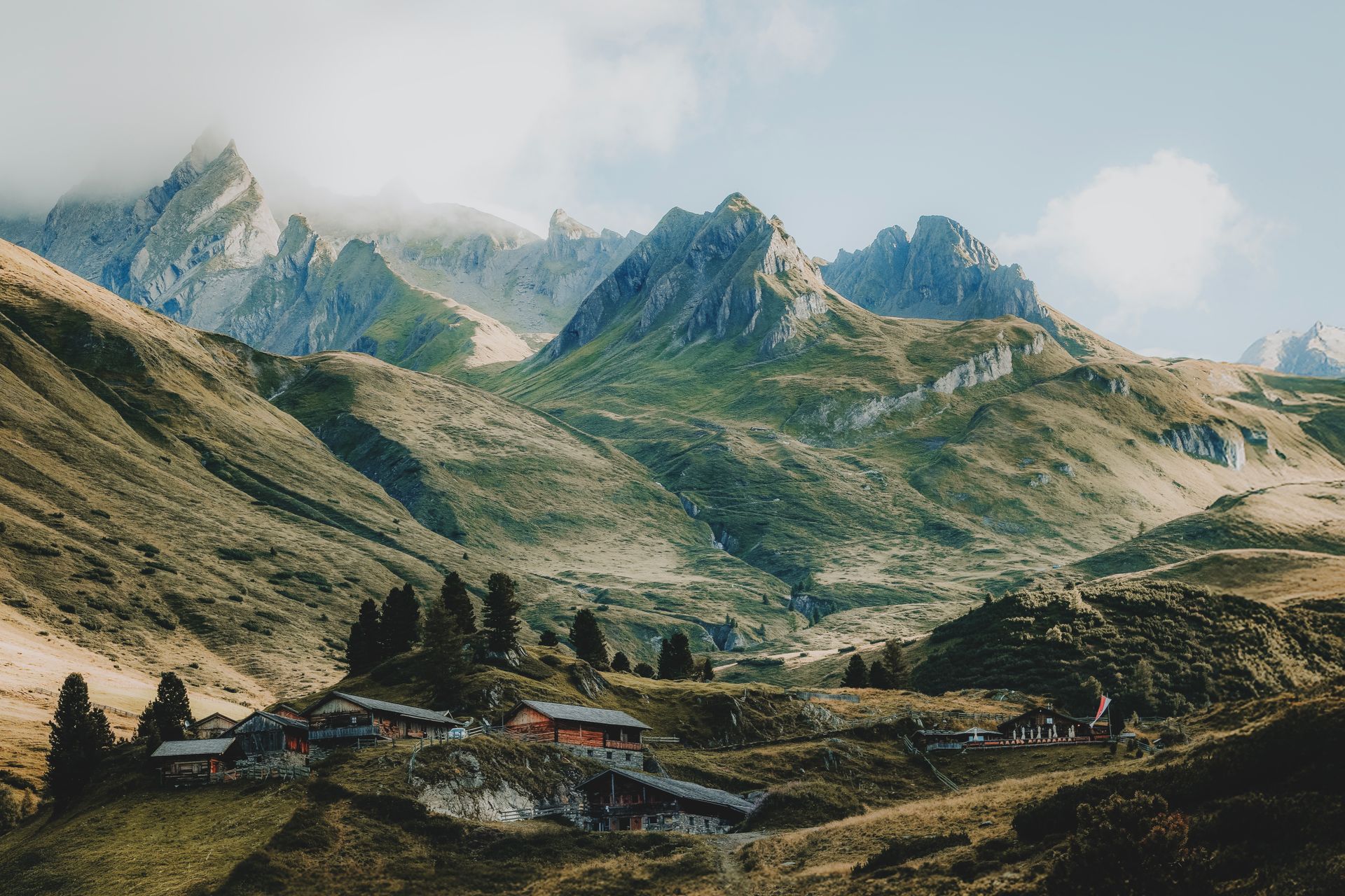 Beautiful mountain landscape with alpine village nestled in the valley under clear skies.
