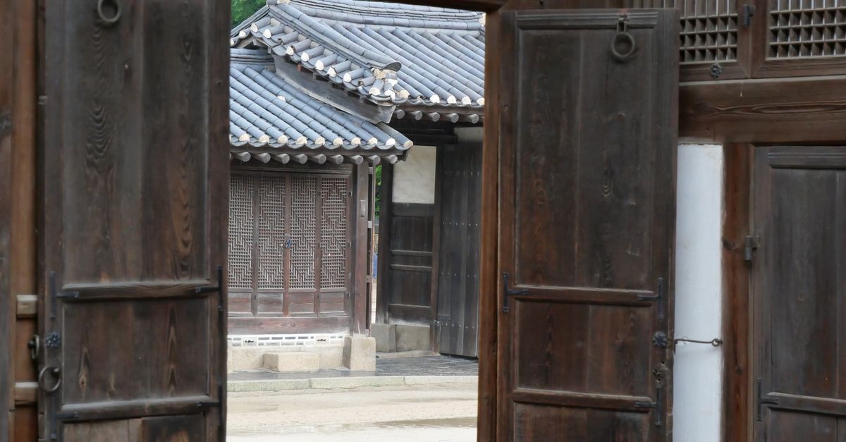 Explore the historic beauty of Bukchon Hanok Village, Seoul, showcasing traditional Korean wooden architecture.