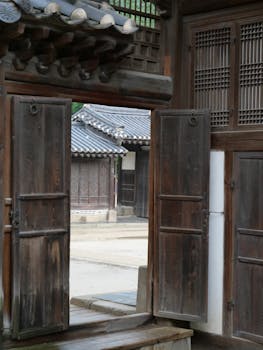 Explore the historic beauty of Bukchon Hanok Village, Seoul, showcasing traditional Korean wooden architecture.