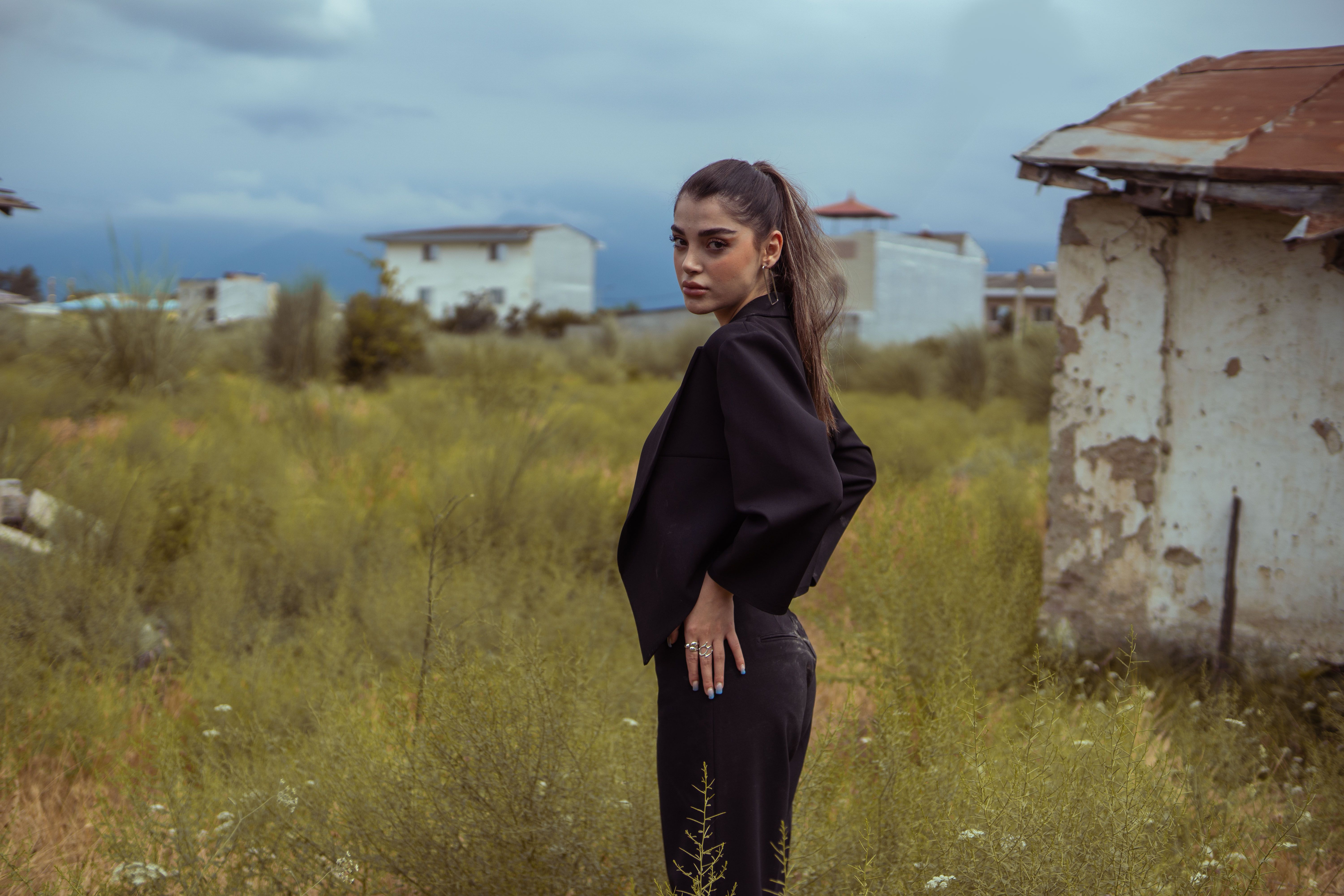 Stylish Woman in Outdoor Rural Setting · Free Stock Photo