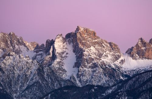 Free Stunning view of the snow-covered Dolomites in Italy under a vibrant pink sunset sky. Stock Photo