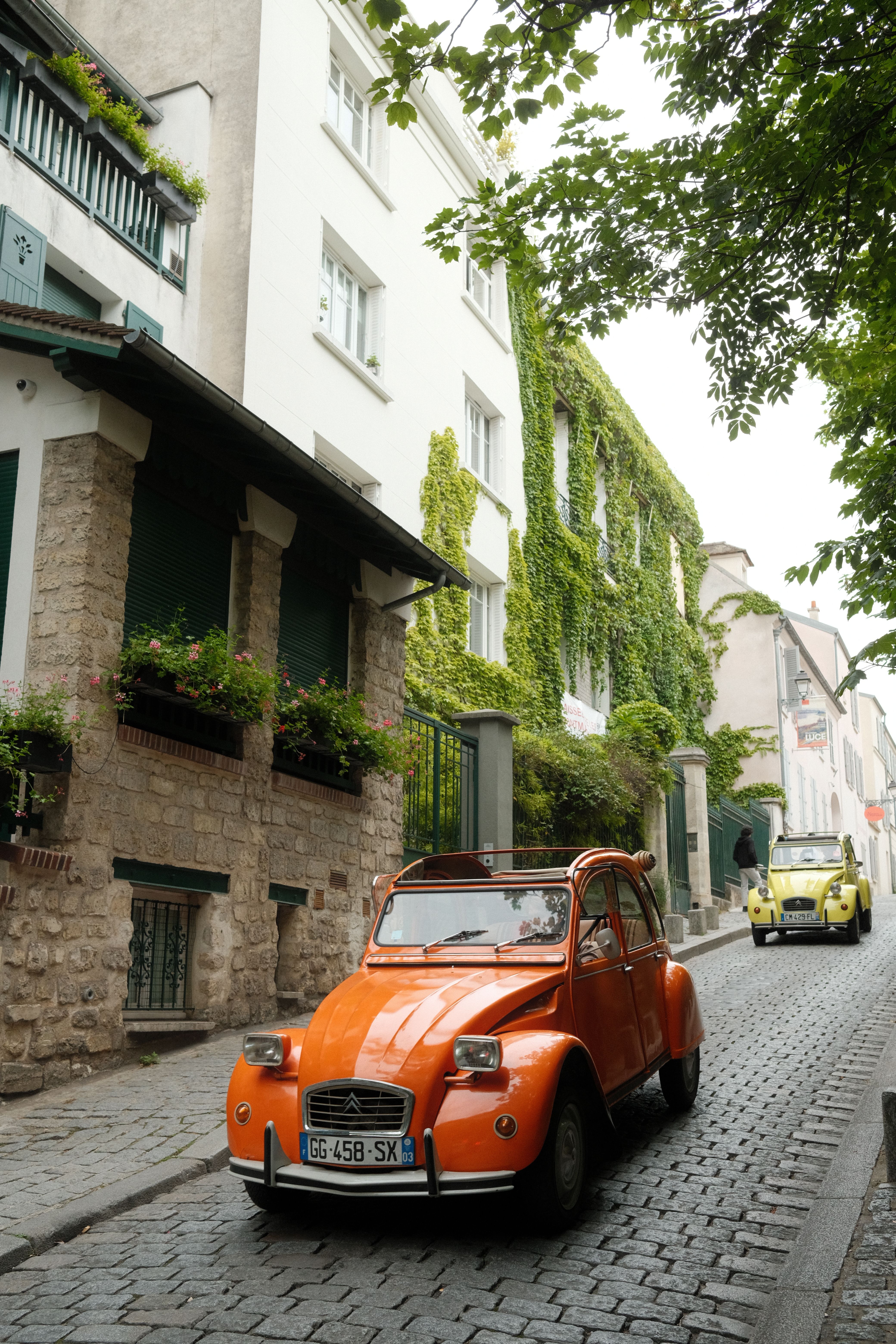 Classic Cars on a Cobblestone Street in Paris · Free Stock Photo