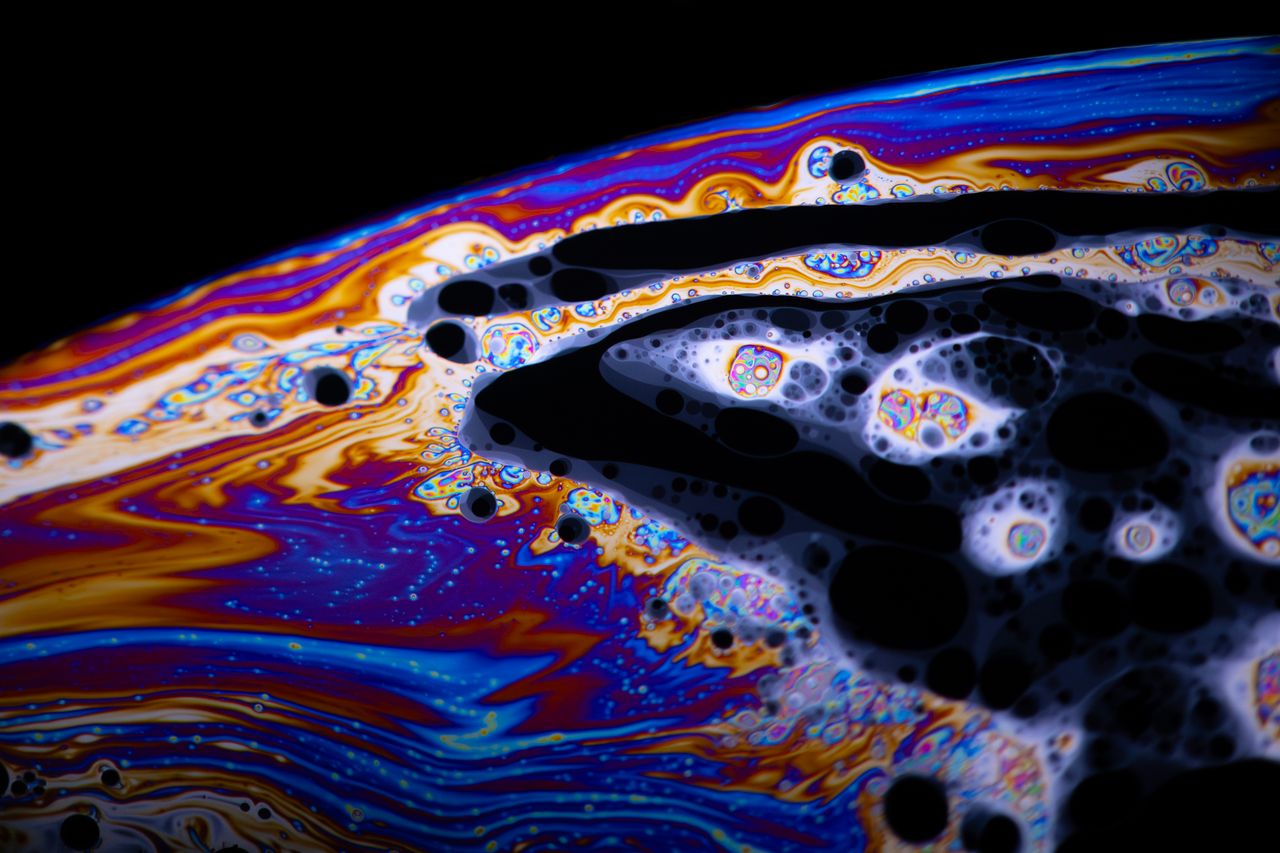 colorful close up of swirling soap bubble textures creating a psychede