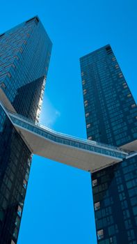Striking view of two modern skyscrapers with a connecting bridge in Montreal, Canada.