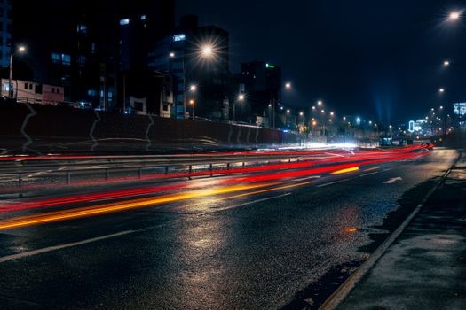 Vibrant long exposure shot of traffic lights in Miraflores, Lima at night showcasing urban beauty.