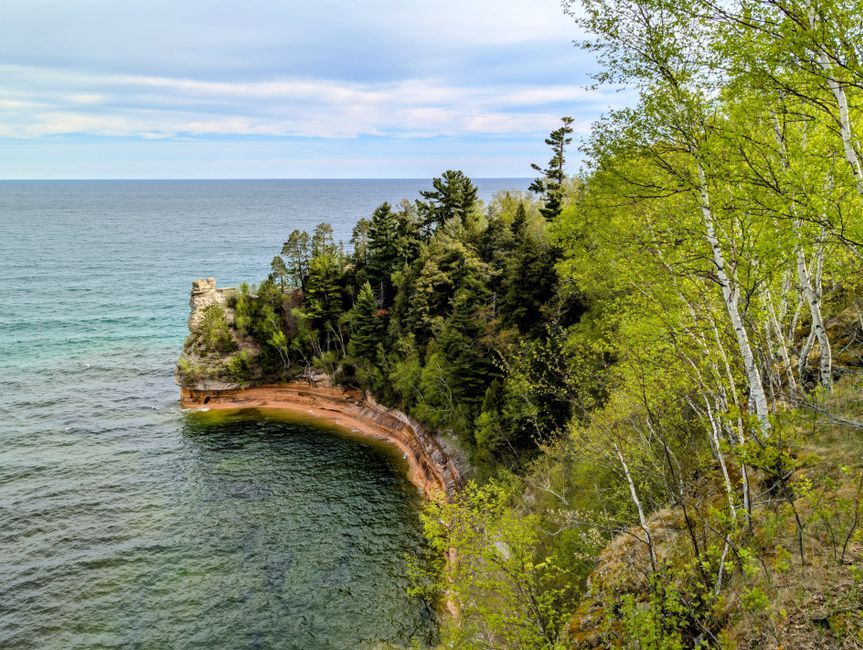 Spectacular Private 20 Minute River Ride Tour Review: Soaring Over Detroit's Iconic Waterway Review 2026 - Scenic view of Pictured Rocks National Lakeshore's cliffs and vibrant spring foliage in Michigan.