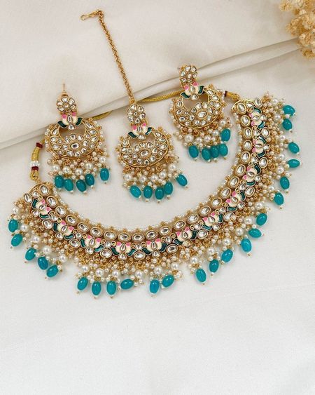 Noor kundan necklace with matching chandbali earrings and maang tikka, finished with turquoise drops