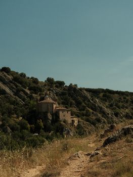 A serene view of the ancient Hermitage of San Saturio in Soria, Spain.