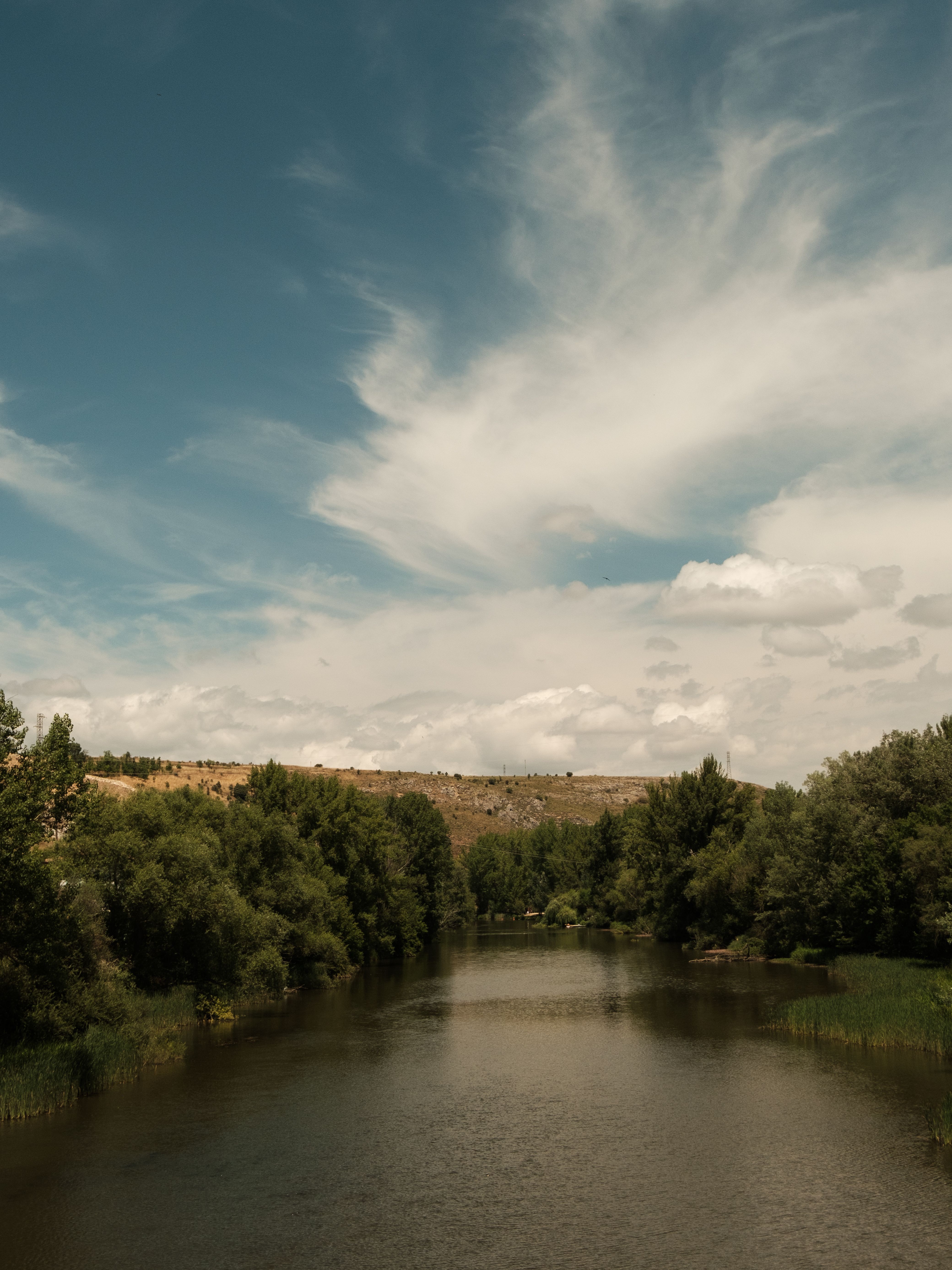 Serene River Under a Vast Blue Sky · Free Stock Photo