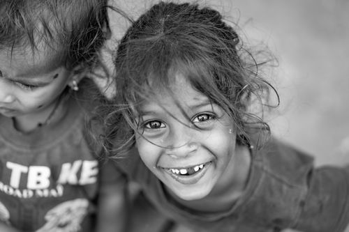 Free Captivating black and white portrait of two smiling children, highlighting joy and innocence. Stock Photo