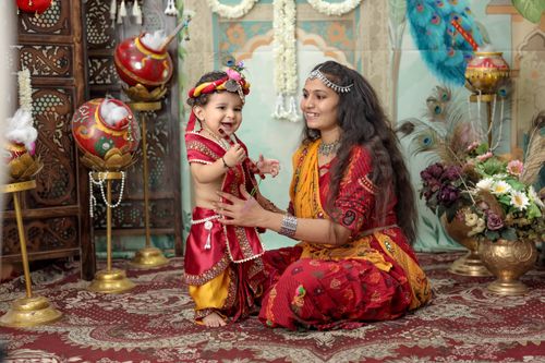 Free Mother and child in vibrant traditional attire celebrating cultural heritage indoors. Stock Photo