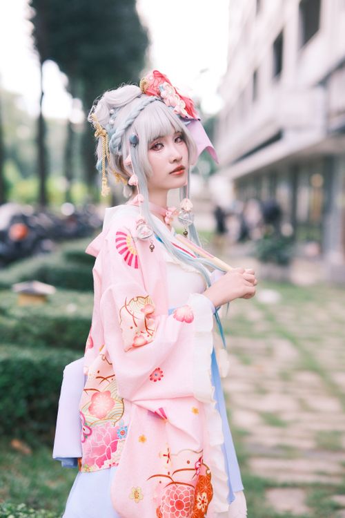 Free Young woman outdoors in a colorful traditional Japanese kimono, exuding elegance and grace. Stock Photo