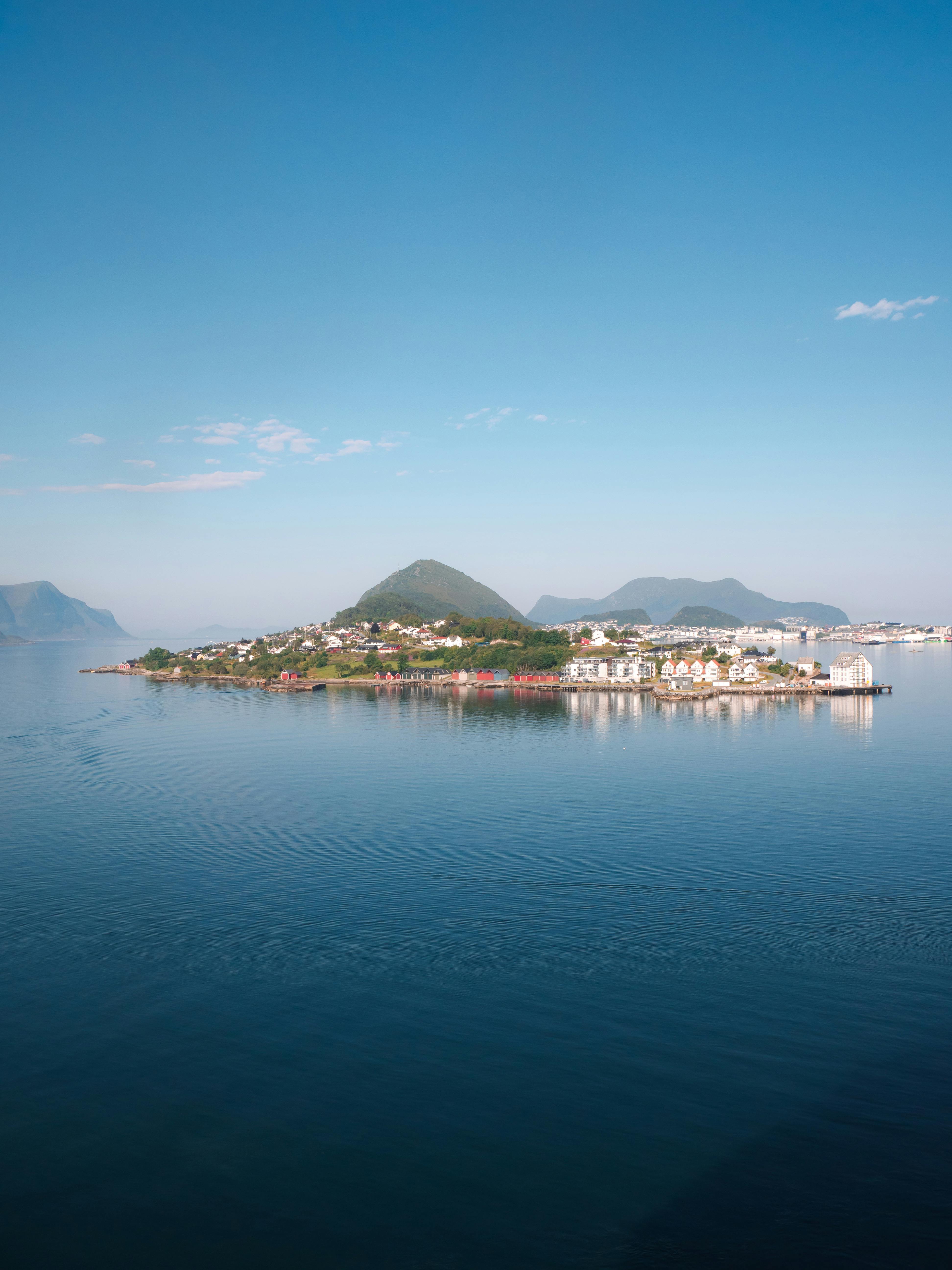A stunning aerial view of a quaint Norwegian island village surrounded by serene waters.