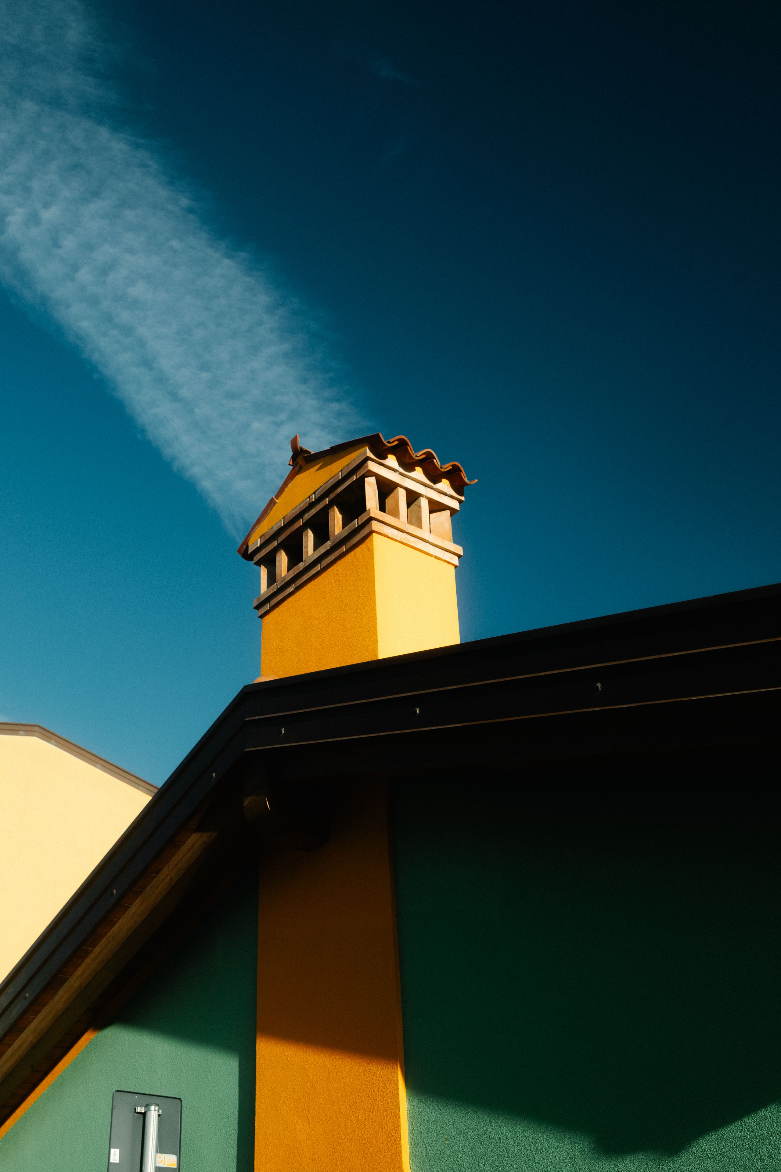 Colorful Architectural Roof with Chimney Under Clear Sky · Free Stock Photo