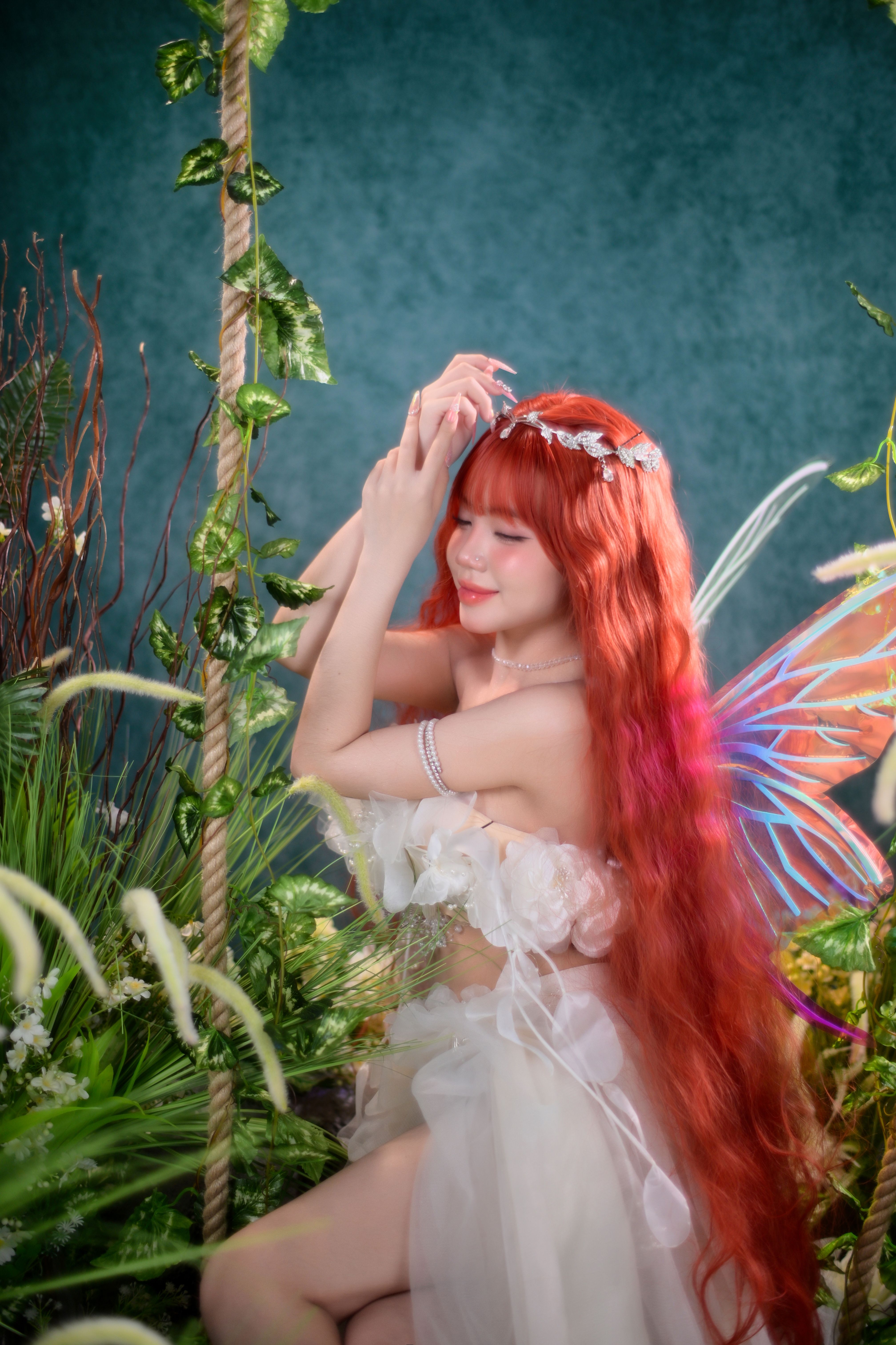 A woman in a white dress with wings and a fairy costume  Free Stock Photo