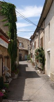 Explore a sunlit alleyway in France's picturesque Provence region, capturing rustic charm. — photo by Marie-francoise Bastien