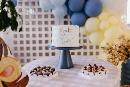 Free Baby shower setup with personalized cake and decorations in soft tones. Stock Photo