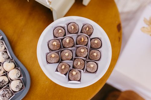 Free Assorted brigadeiros and beijinhos on elegant trays for dessert. Stock Photo