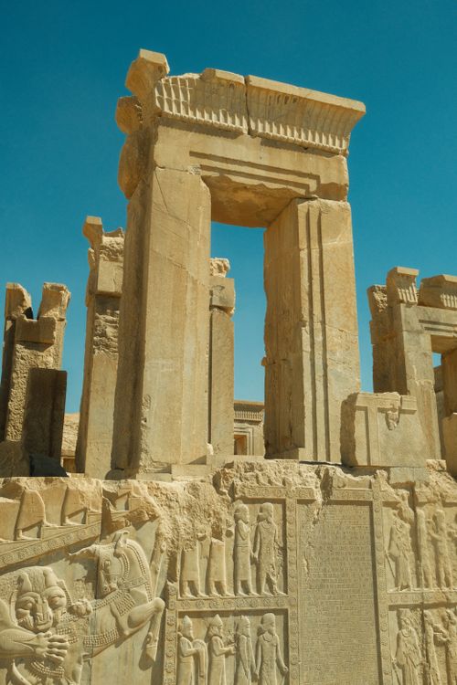 Free Explore the majestic ancient stone structures of Persepolis under clear blue skies. Stock Photo